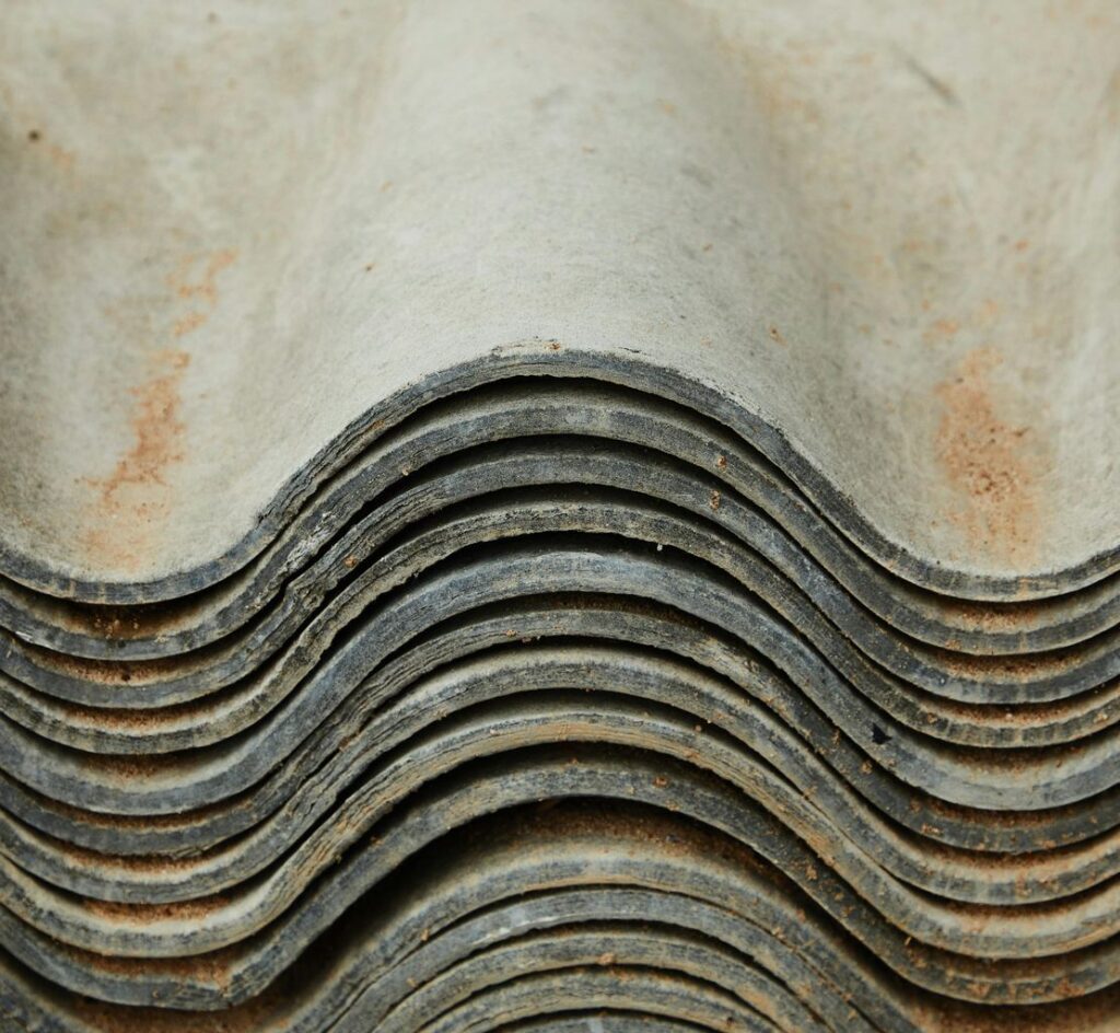 Background of heap of aged rough shabby slate for repairing roof of house