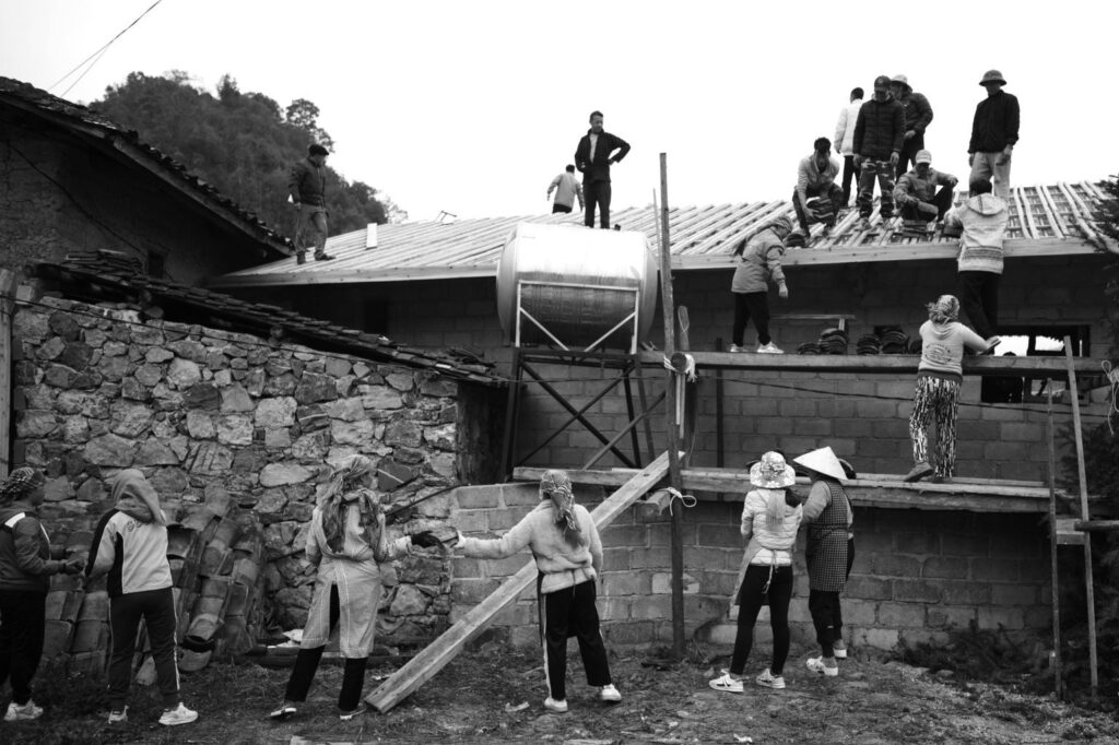 People Building a House in Black and White